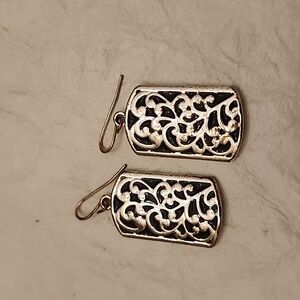 Silver tone earrings with scroll pattern